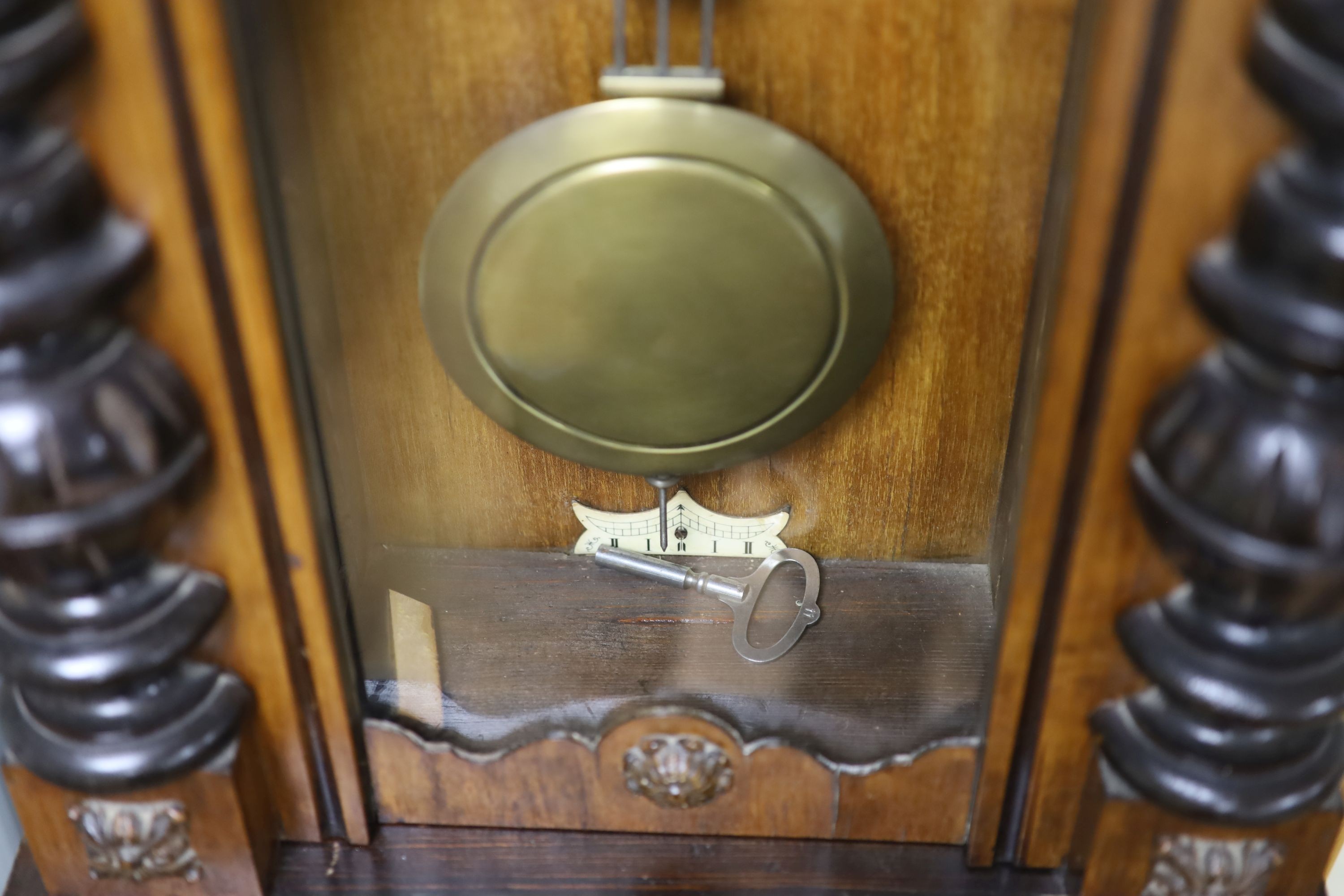 A 19th century Continental regulator in architectural walnut case, with key and gridiron pendulum, 116cm